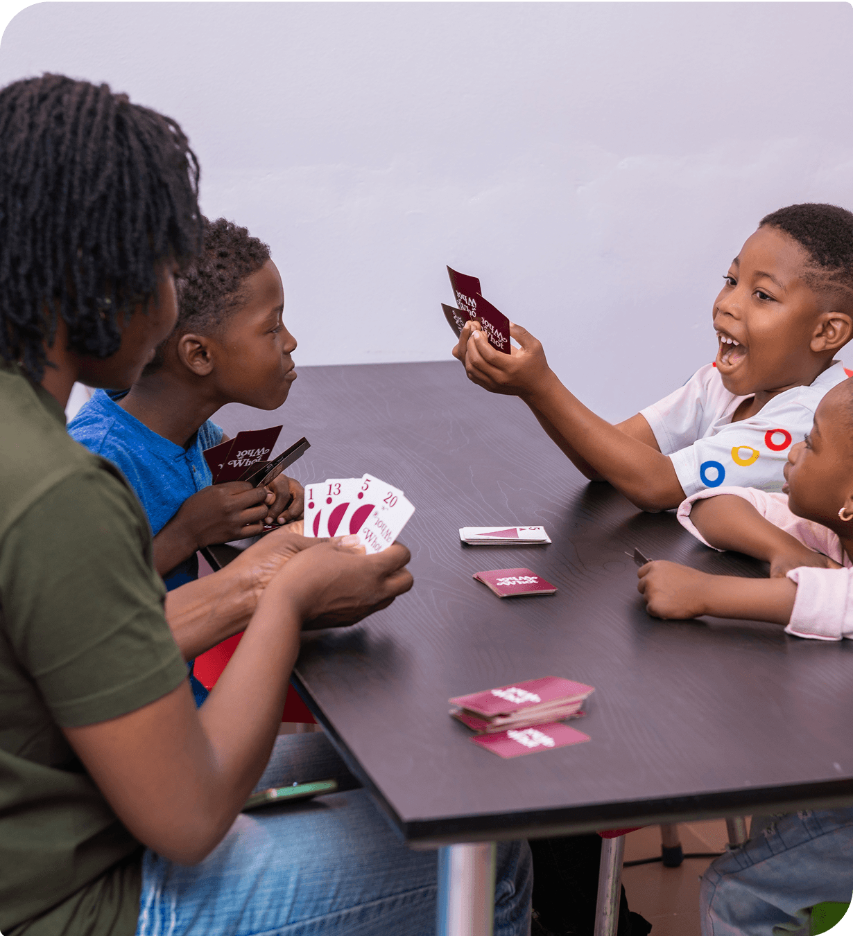 Children playing card game at table